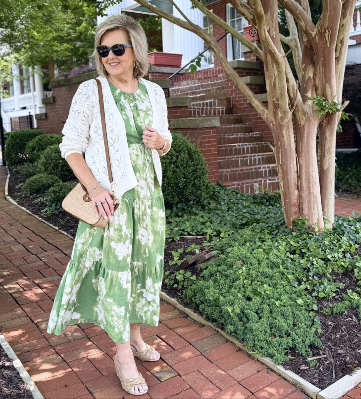 Soft green boho-inspired floral maxi with white crochet cardigan and neutral heels